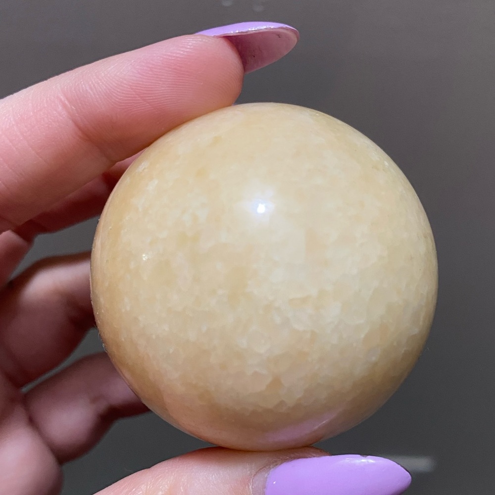 Small honey calcite crystal sphere.